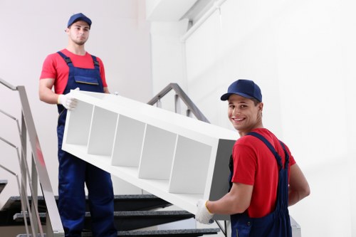 Moving boxes and furniture during a Bishopsgate removals service in a busy city setting