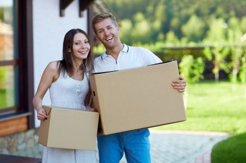 Mover carrying furniture carefully with protective handling