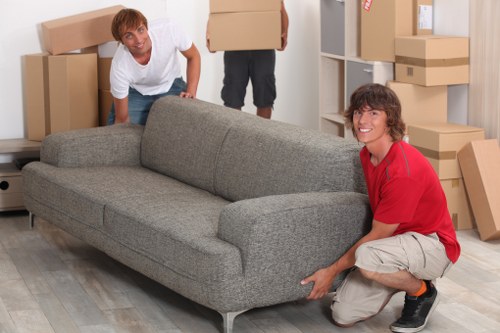 Loading boxes and furniture into a van near Bishopsgate buildings