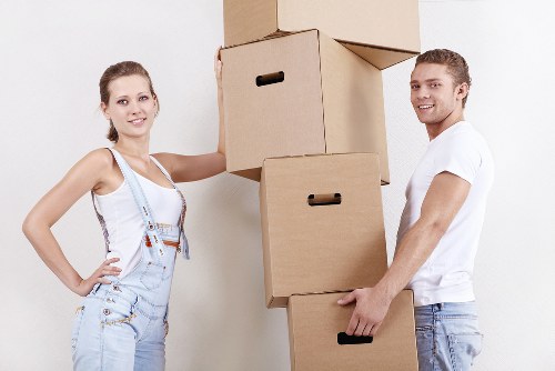 Professional movers carrying furniture through a Bishopsgate building